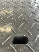 Metallic diamond plate pattern on a flat surface
