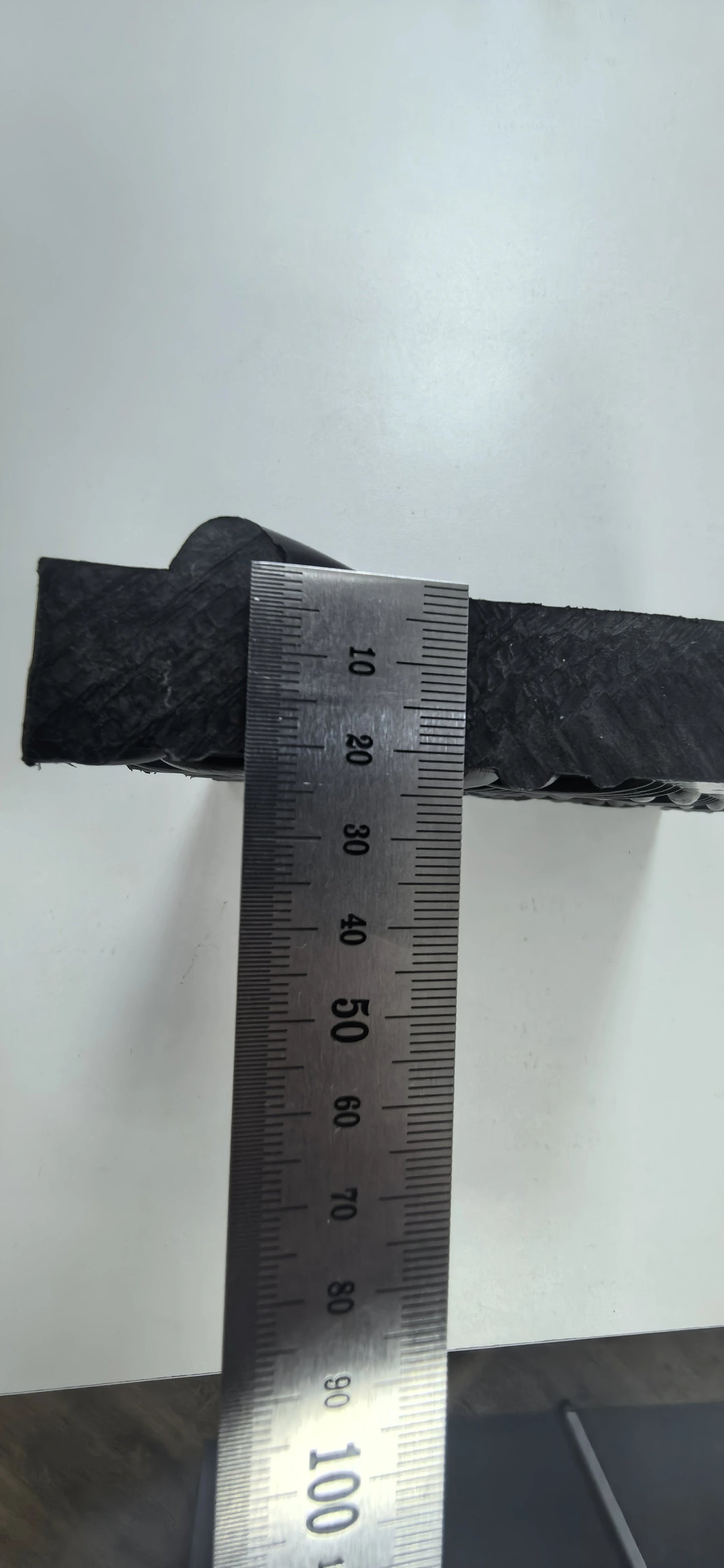 Metallic strip with a ruler for measurement on a white background