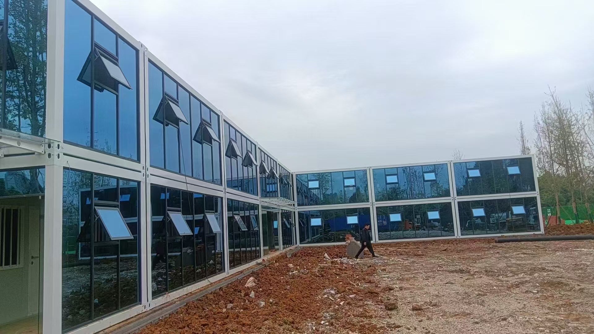 Modern building with large glass windows on a cloudy day