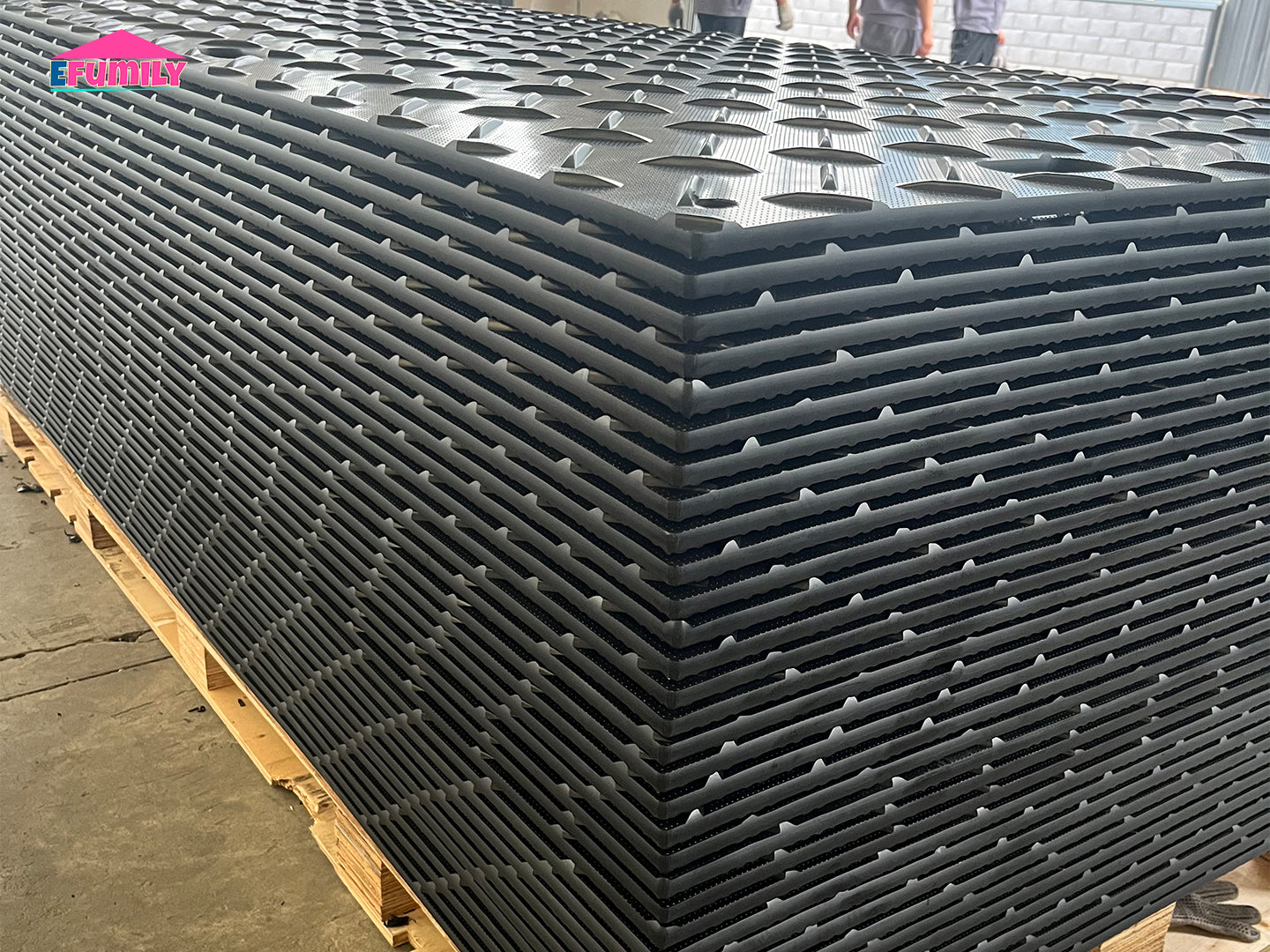 Stack of black plastic trays on a pallet with 'Exponets' branding.