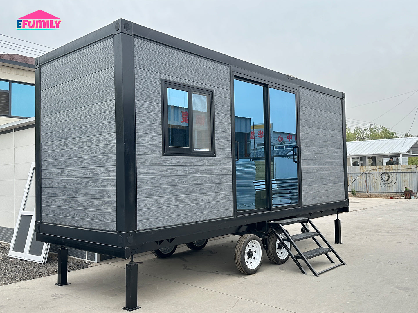 Modular building on wheels with EFUMILY branding in the background
