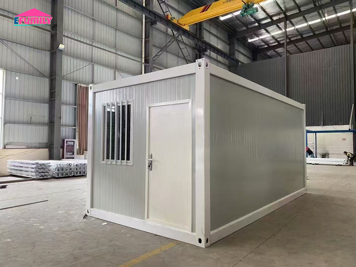 Modular building container in a warehouse setting with visible branding.
